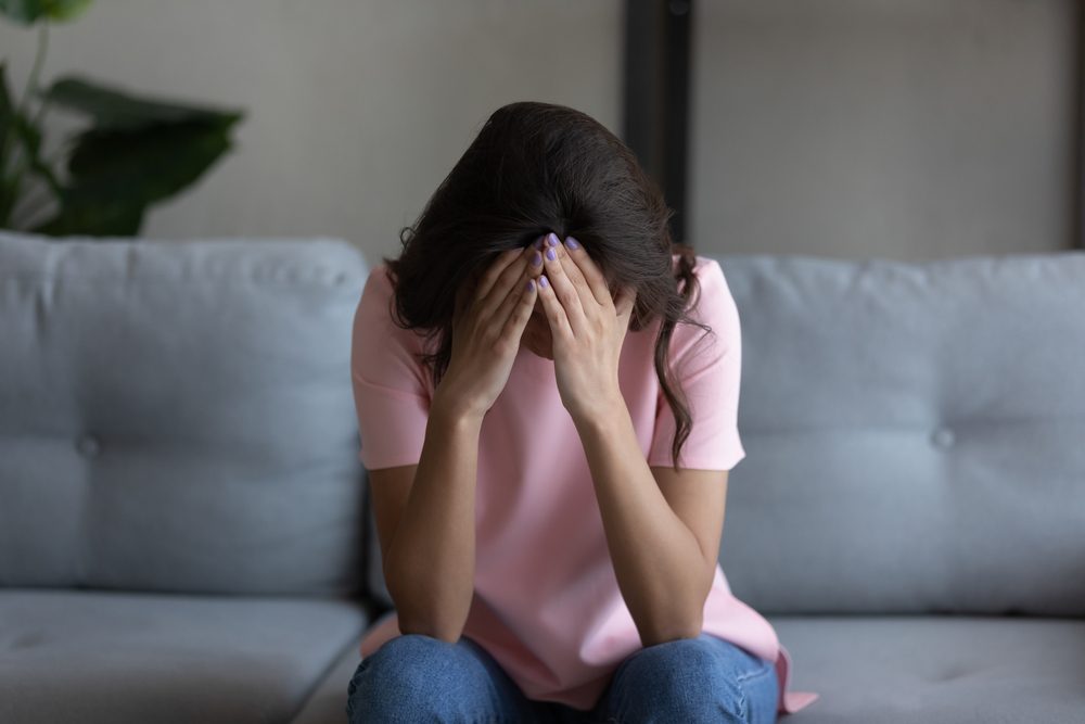Depressed unhappy young arab mixed race woman feeling hopeless alone at home