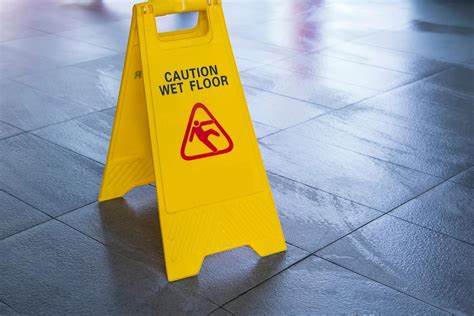 Caution wet floor sign highlighting slip and fall accident risk in California.