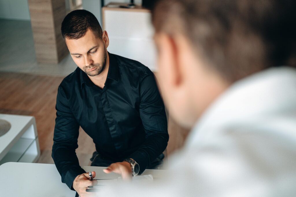 Attorney meeting with male client about underinsured motorist claim in California.