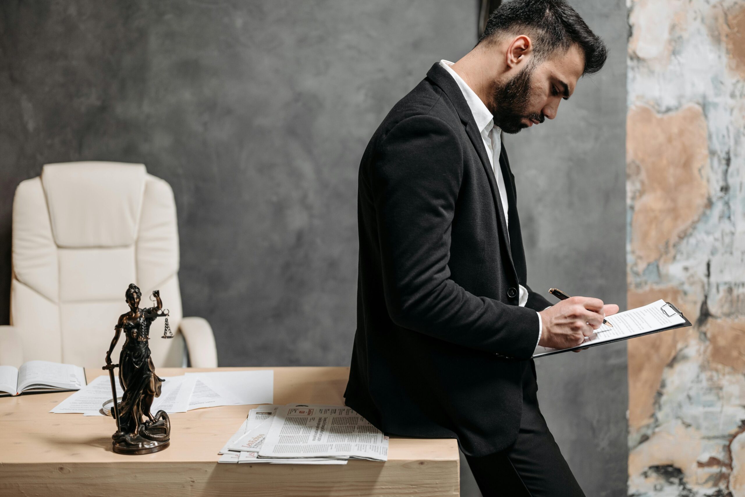 California slip and fall lawyer sitting at desk reviewing case files.