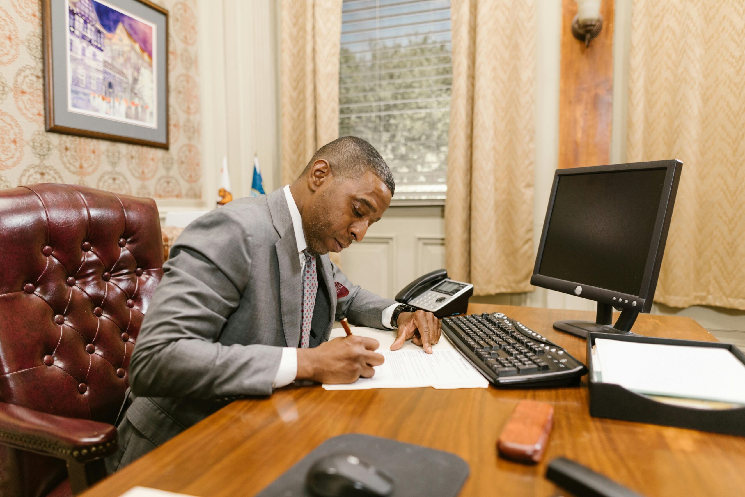 Catastrophic injury lawyer working at desk on a client’s case.