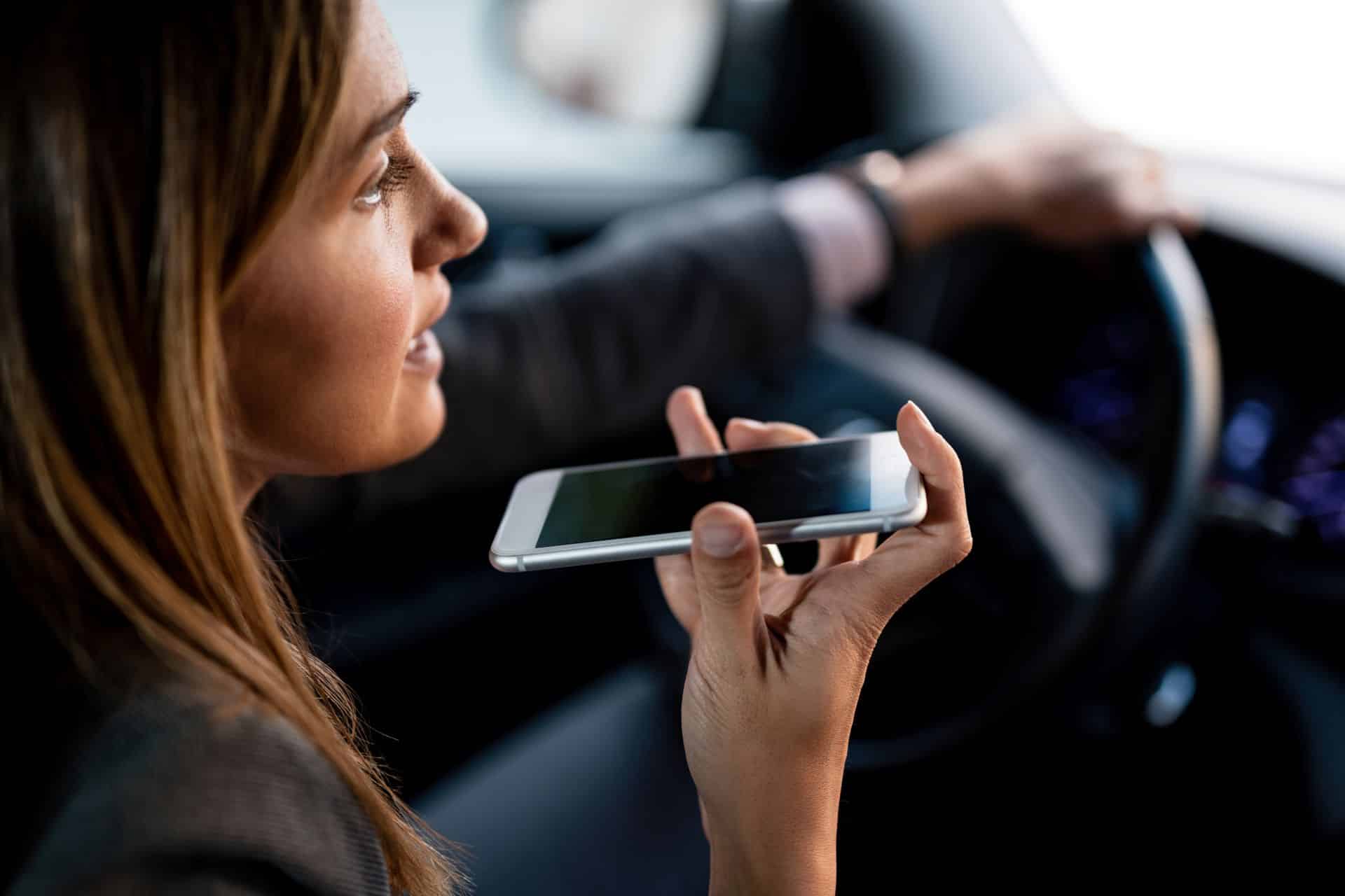 Motorist using a smartphone while driving, representing a distracted driving accident claim and negligent driver liability in Sacramento.