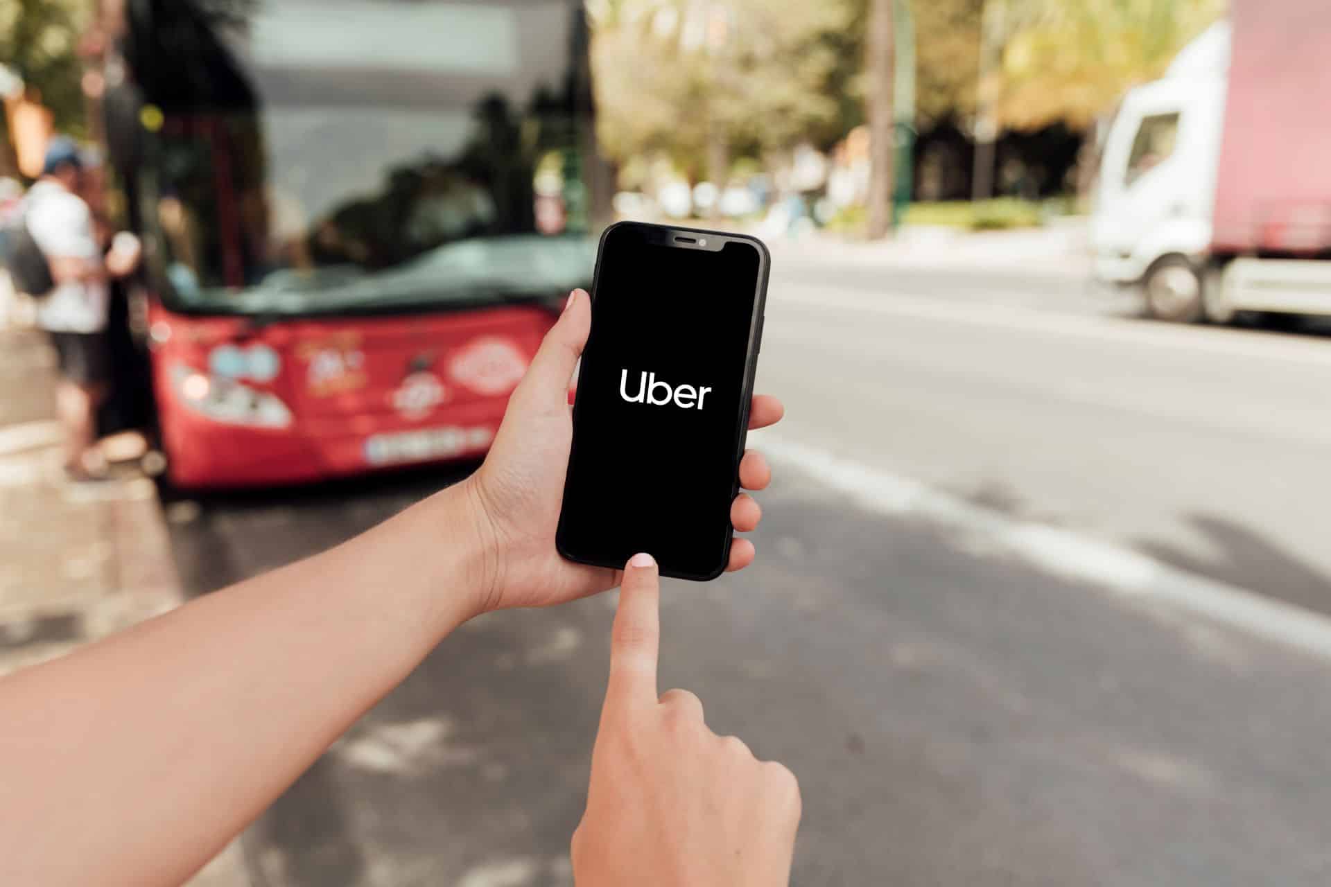 Rideshare passenger using the Uber app on a smartphone, illustrating a Los Angeles Uber accident and rideshare injury case.
