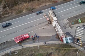 An aerial view of an overturned commercial truck accident scene illustrates the complex evidence often required to prove serious injuries, liability, and long-term damages in high-stakes truck accident claims.