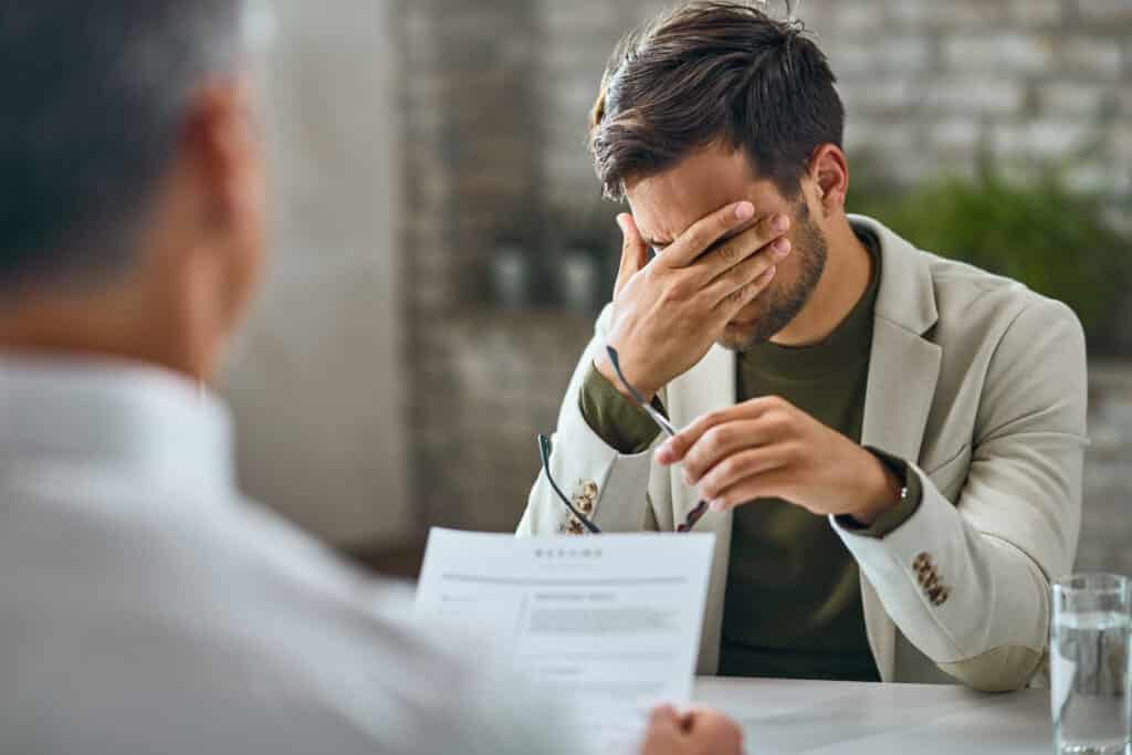 A personal injury attorney explains legal documents to a concerned client during a consultation in Fontana, California.
