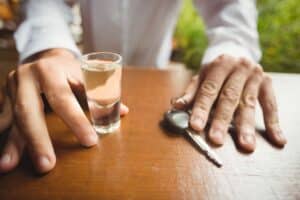 Car keys placed beside an alcoholic drink, symbolizing drunk driving accidents and legal claims against impaired drivers.