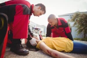 Person reaching to rescue a drowning victim, illustrating serious personal injuries that may result in a lost wages claim after a California accident.